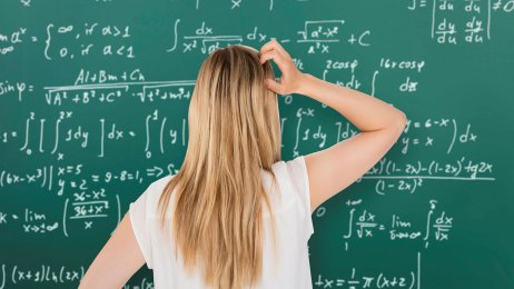 Matte Student som står foran en tavle med matematiske formler