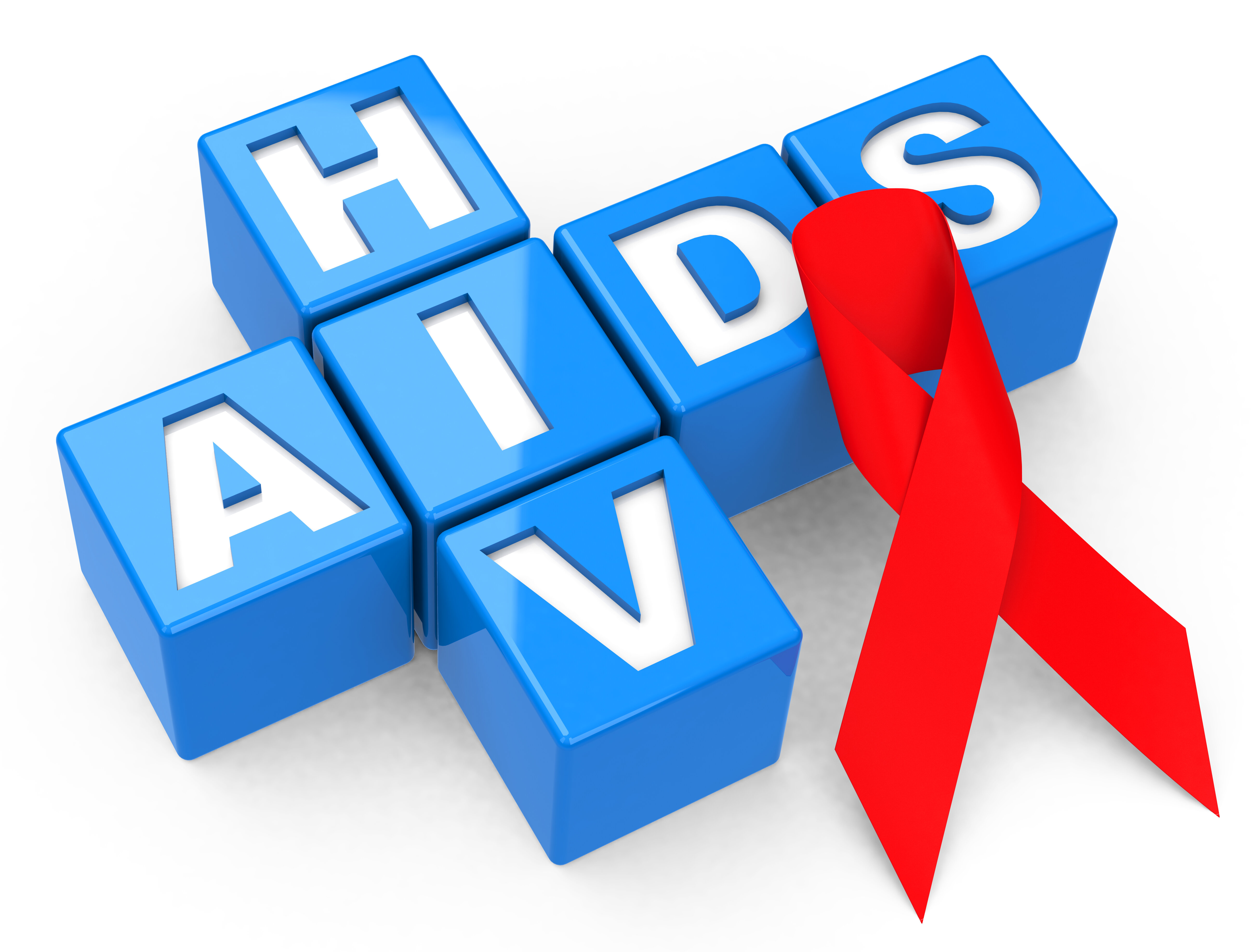 En rød sløyfe ligger oppå bokstavene til hiv/aids. 